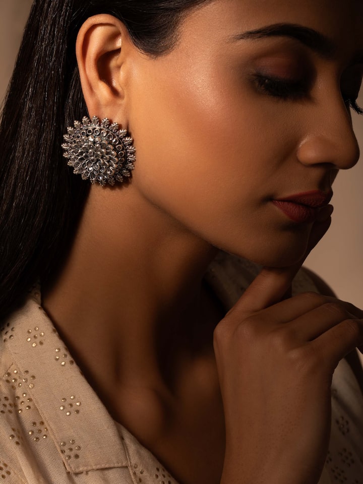 Side view of Smithing Stud Earrings displaying elegant design and silver finish.