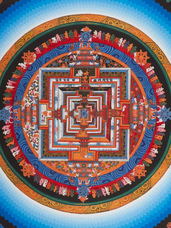 Detailed view of Thangka mandala painting, highlighting the complex patterns and vibrant hues.