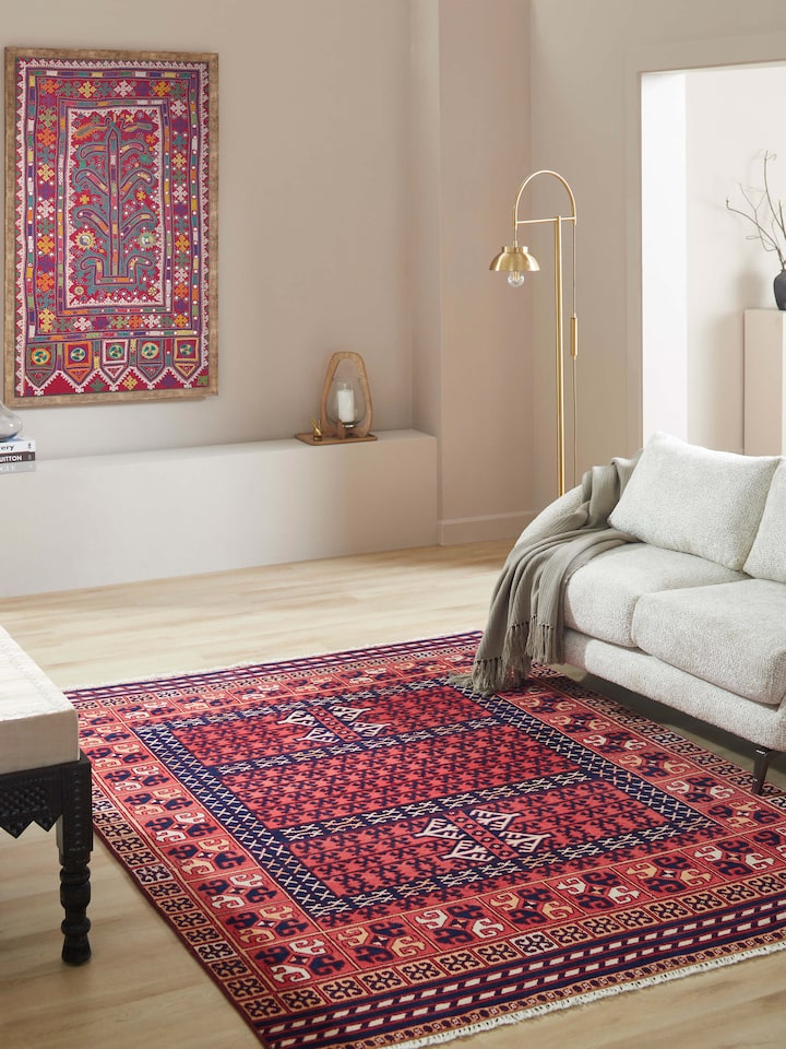Close-up of Kazak tribal red Agra wool hand-knotted rug (6x9 ft), focusing on the detailed pattern and texture.