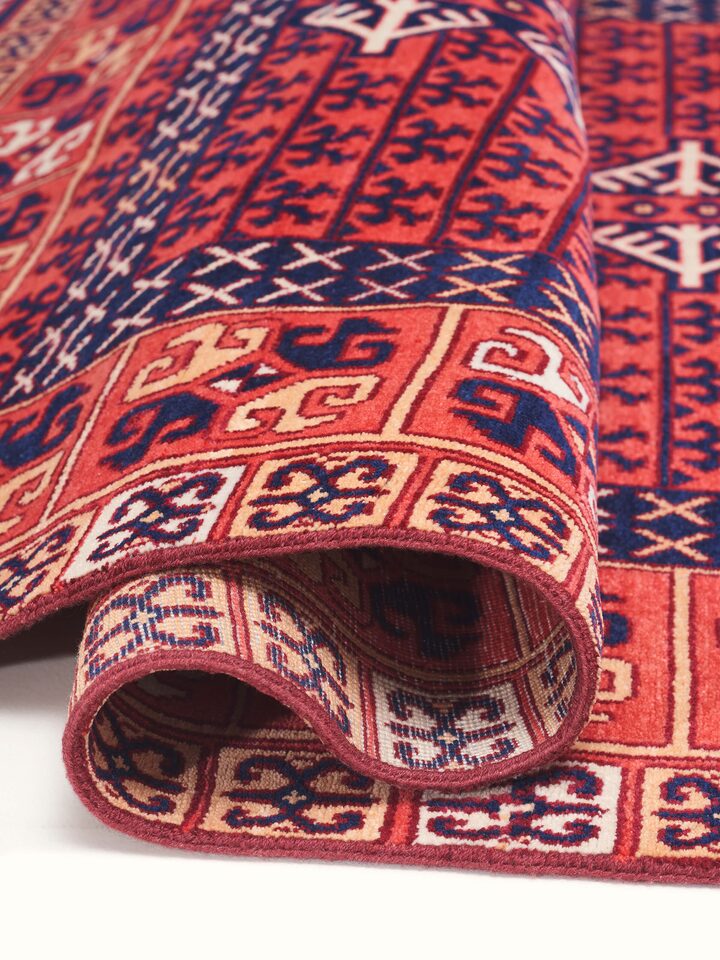 Detailed view of Kazak tribal red Agra wool hand-knotted rug (6x9 ft), highlighting the intricate hand-knotted craftsmanship.