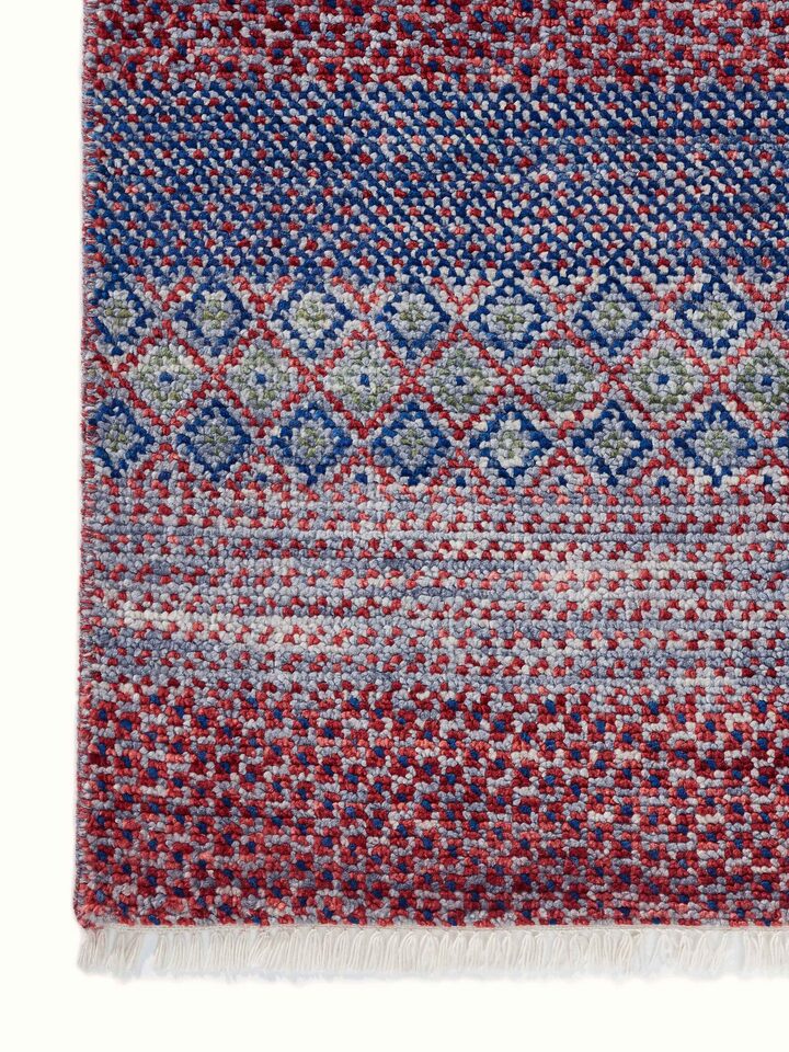 Close-up view of the wool and viscose hand-knotted rug featuring the grass pattern, emphasizing the rug’s plush texture and quality