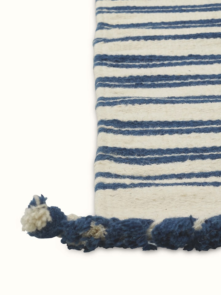 Overhead view of Geo Border Ivory Blue Gujarat Wool & Cotton Panja Dhurrie, emphasizing the full geometric design and color scheme.
