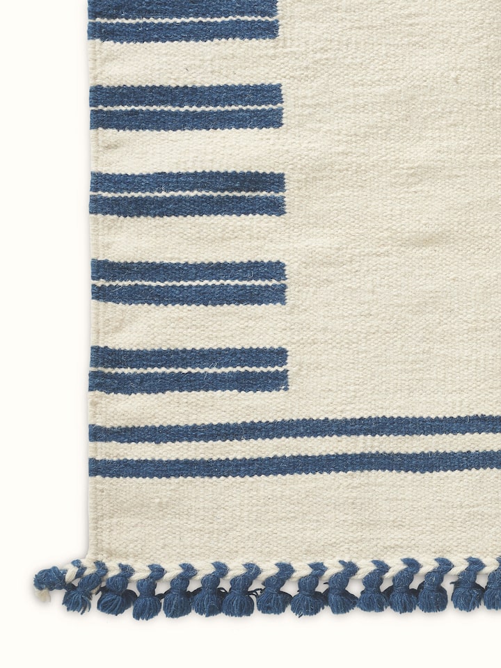 Detailed view of Geo Border Ivory Blue Gujarat Wool & Cotton Panja Dhurrie, focusing on the texture and color pattern.