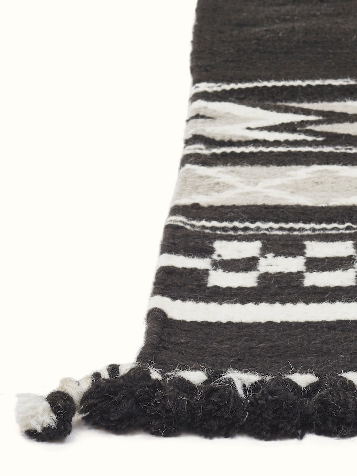Detailed view of Geo border dark brown Gujarat wool & cotton panja dhurrie kharad (4x6 ft), emphasizing the color and texture