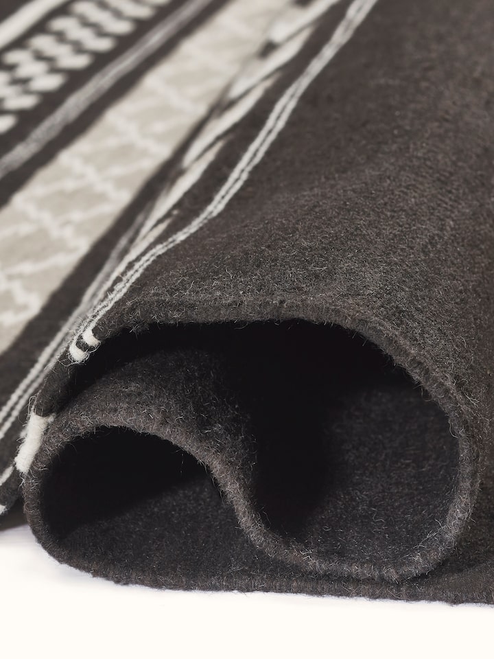 Close-up of Geo border dark brown Gujarat wool & cotton panja dhurrie kharad (4x6 ft), showing the fabric quality and pattern
