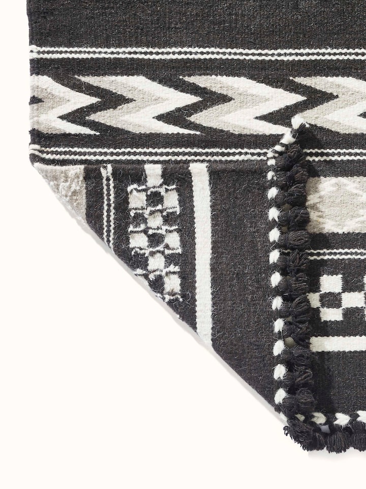 Geo border dark brown Gujarat wool & cotton panja dhurrie kharad (4x6 ft) with detailed view of the border design and wool texture