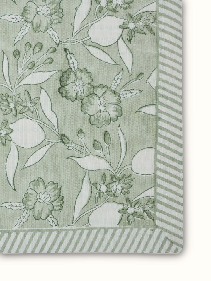 Angled view capturing hand block print detail and textured linen fabric.