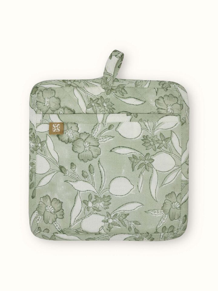 Perspective view of Anika green floral cotton Sanganeri block printed pot holder demonstrating the design and functionality.