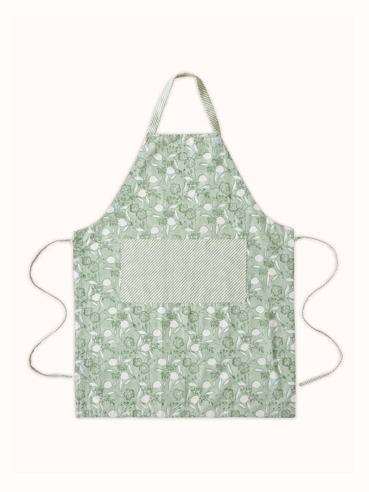 Full view of green floral cotton Sanganeri block printed apron showing the floral pattern and fabric.