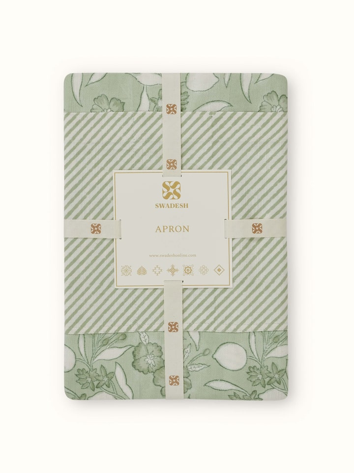 Green floral cotton Sanganeri block printed apron worn to showcase its fit and design.