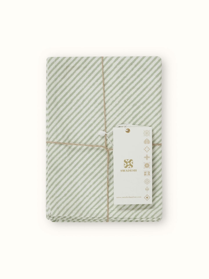 Anika green floral cotton Sanganeri block printed dish towel in use, showing its practical application in a kitchen setting.