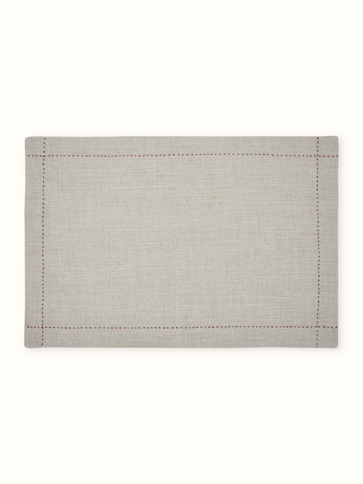 Front view of beige linen table mat set with subtle hand embroidery, ideal for elegant dining.