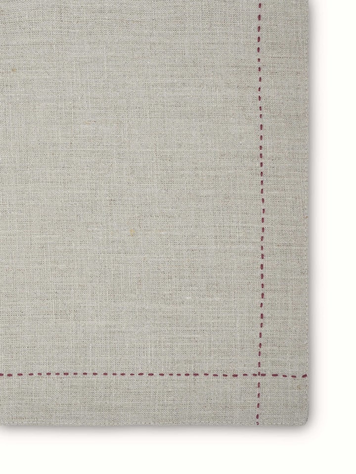 Angled view of linen table mats highlighting embroidery and clean finish in beige tone.