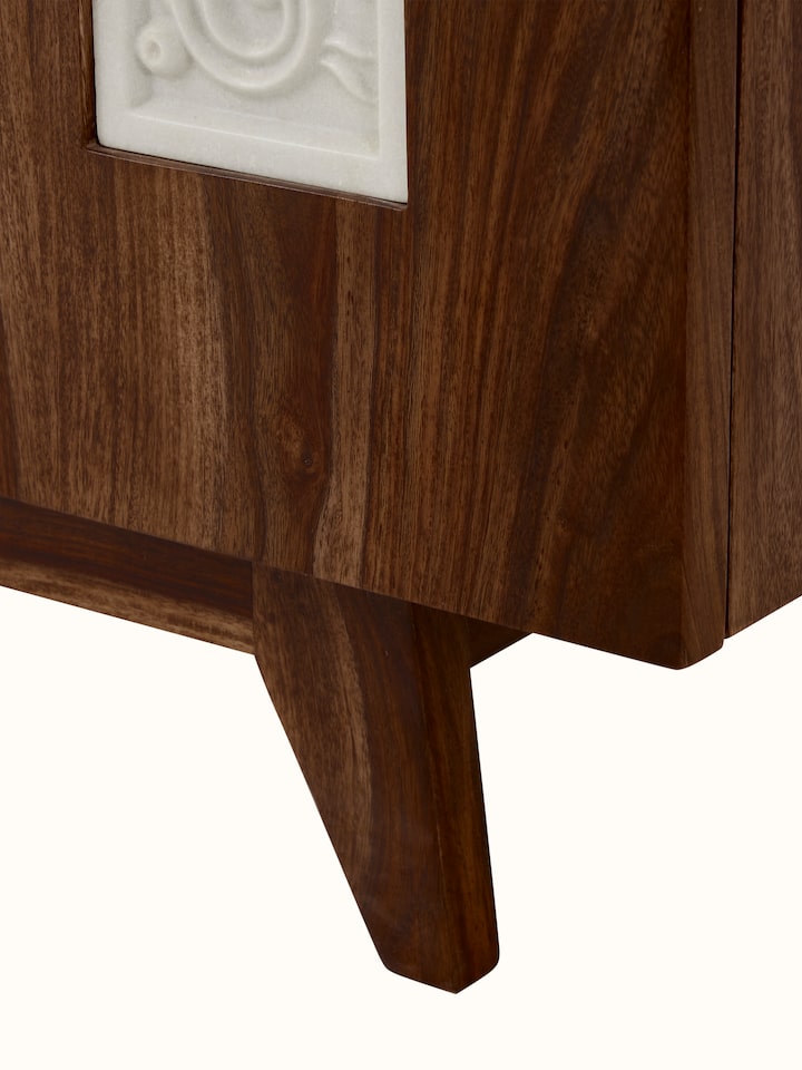 Detailed side view of the carved Sheesham wood sideboard, focusing on the elegant wood carving and marble top.