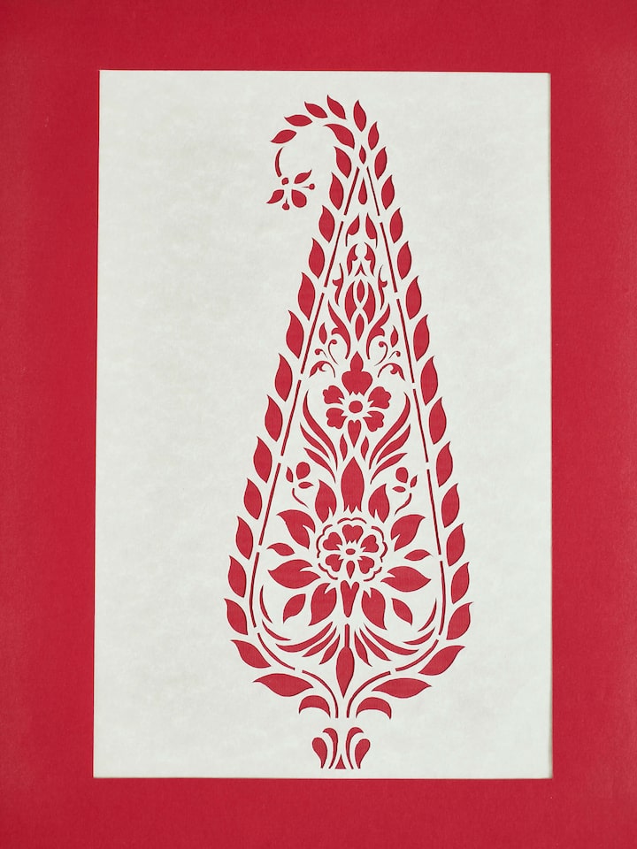 Close-up of Sanjhi paper stencil Mughal kairi wall art focusing on delicate patterns.