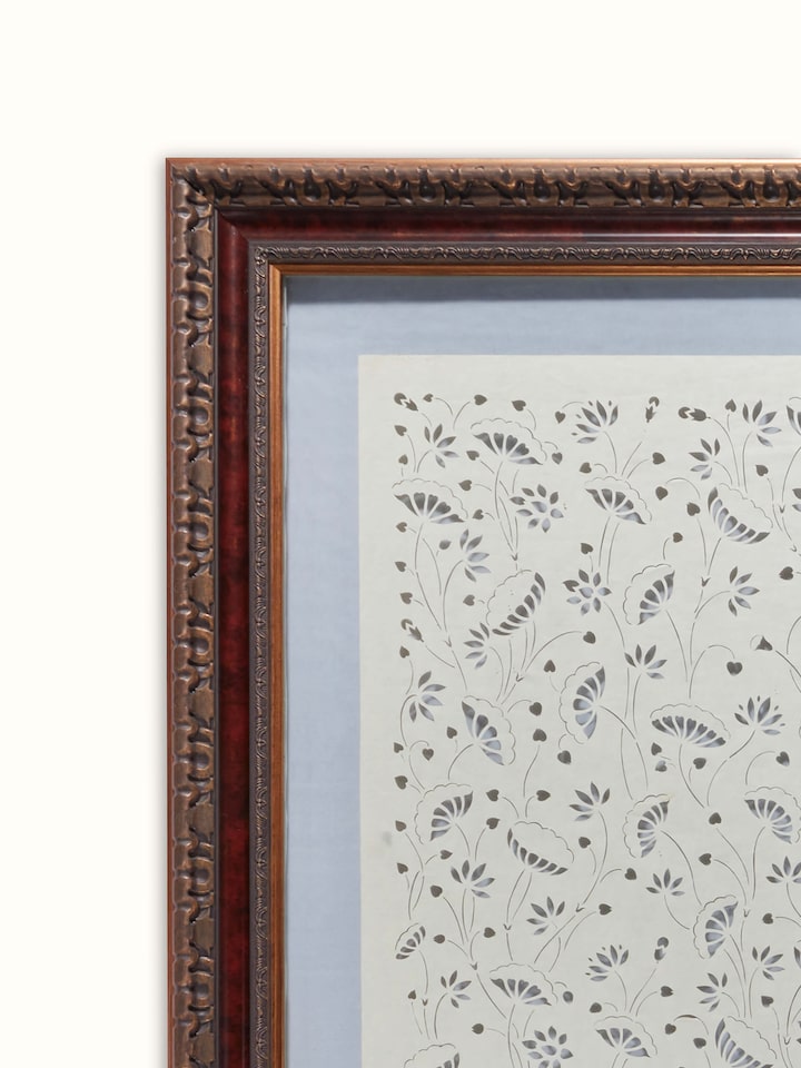 Close-up of Sanjhi paper stencil kamal talai wall art focusing on the fine cuts and detailed patterns