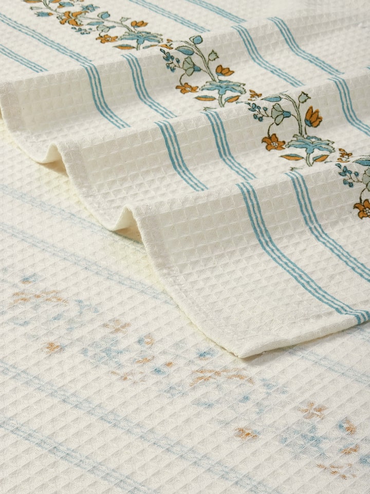 Angled view of Palampore Stripe White Floral Cotton Sanganeri Block Printed Bath Towel (XL), displaying its full length and print design.
