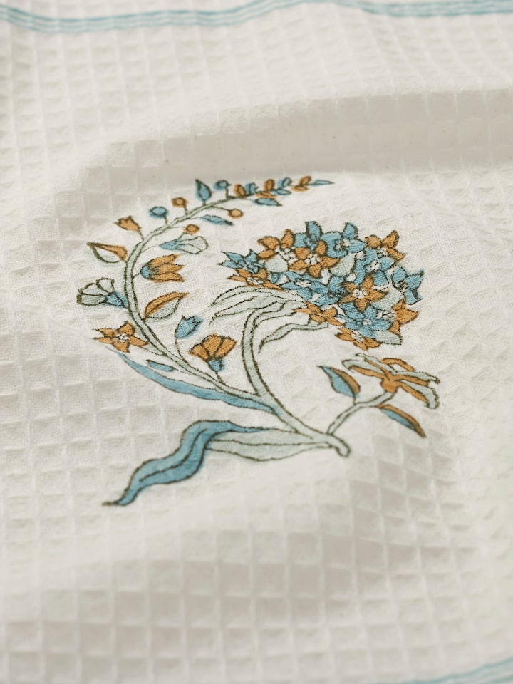 Detailed view of Palampore white floral bath towel, focusing on the texture and block print design.
