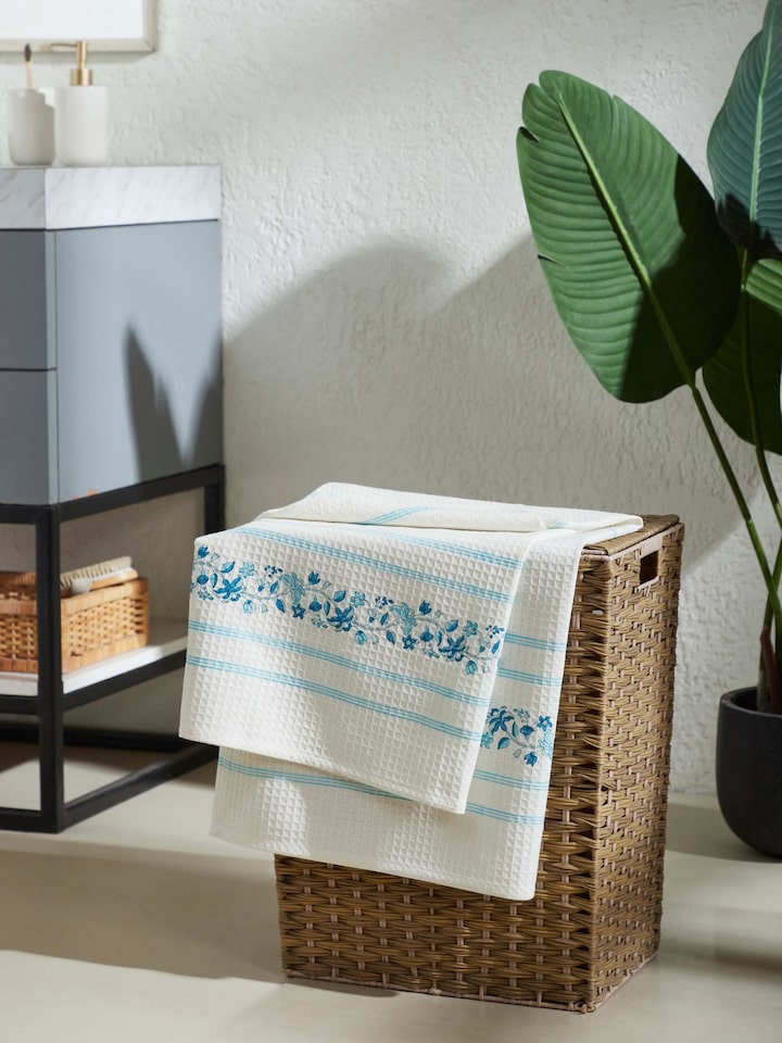 Close-up of Palampore blue floral cotton bath towel featuring stripe and block print details