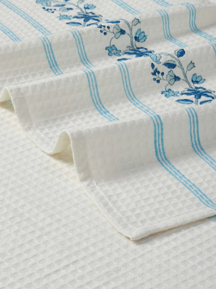 Full view of Palampore blue floral bath towel highlighting the stripe and block print design