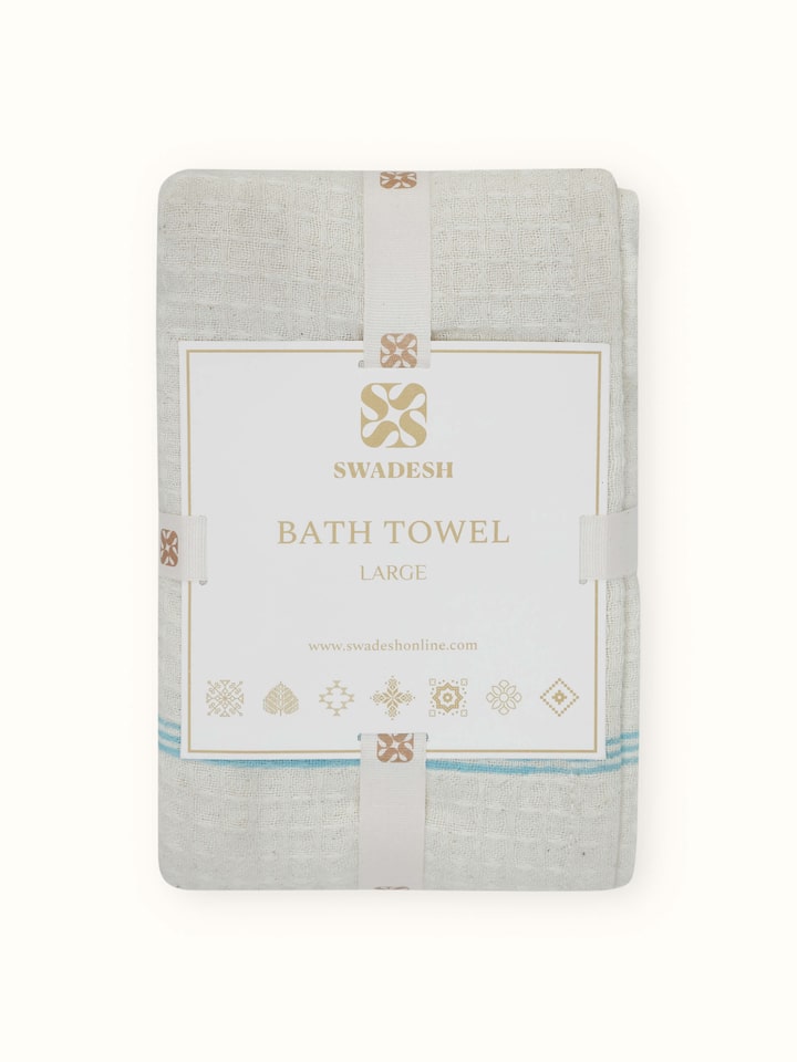 Perspective view of Palampore Buta blue floral cotton Sanganeri block printed bath towel (L) showing its overall design and floral pattern.
