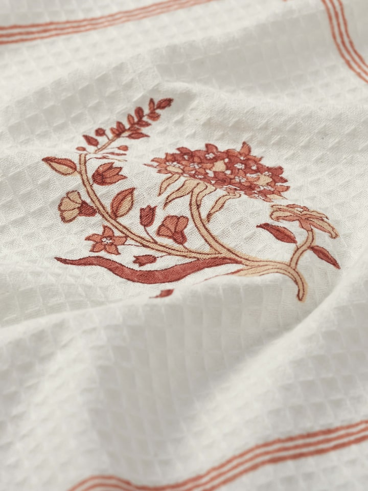 Detailed view of Palampore buta peach floral cotton Sanganeri block printed bath towel (L) focusing on the texture and block print accuracy.