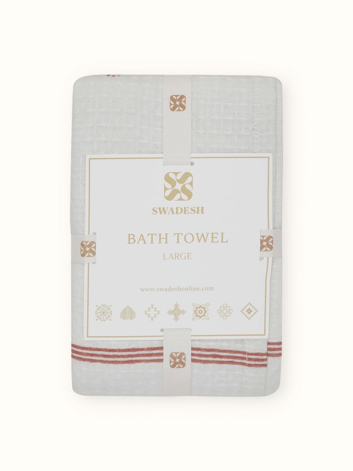 Perspective view of Palampore buta peach floral cotton Sanganeri block printed bath towel (L) capturing its overall design and print pattern.