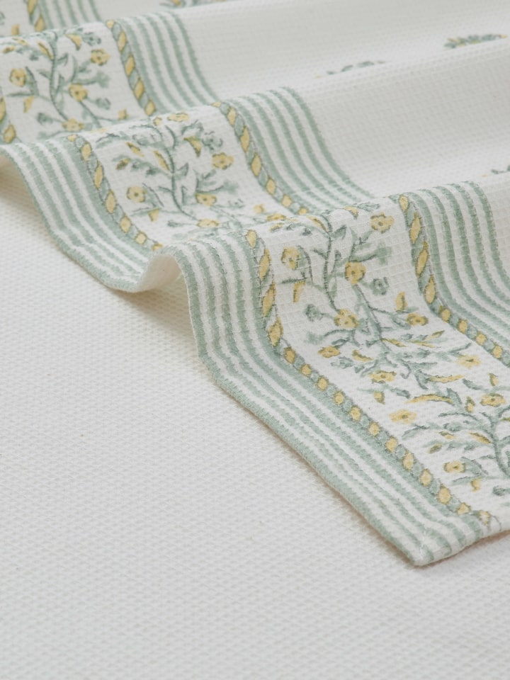 Ambi border yellow floral cotton Sanganeri block printed bath towel (XL) folded, emphasizing the intricate block print.