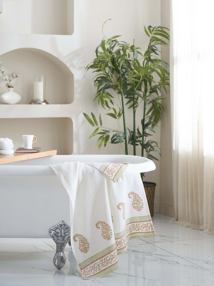 Close-up of Ambi border peach floral cotton Sanganeri block printed bath towel (XL) highlighting the peach floral block print and border details.