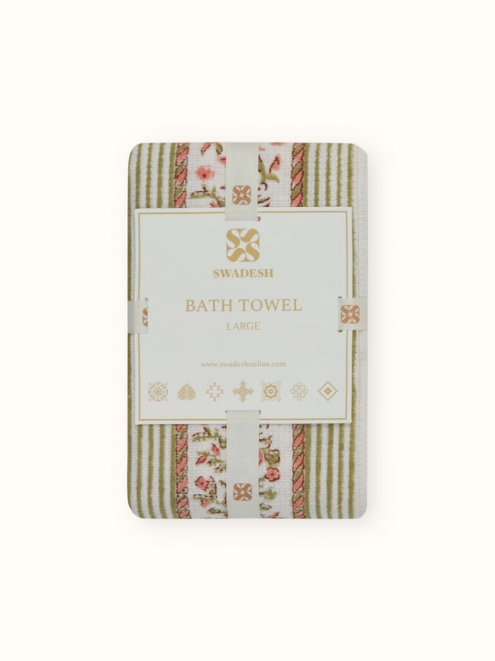 Angled view of Ambi allover peach floral cotton Sanganeri block printed bath towel (L), illustrating its full design and use.