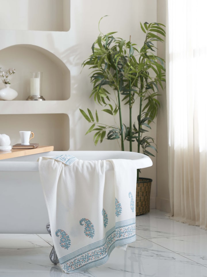 Close-up of Ambi border blue floral cotton Sanganeri block printed bath towel (XL), highlighting the floral pattern.