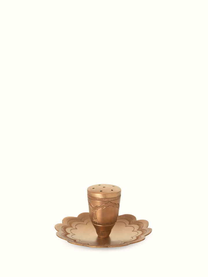 Front view of polished brass incense stick holder showcasing its elegant, reflective surface and detailed design