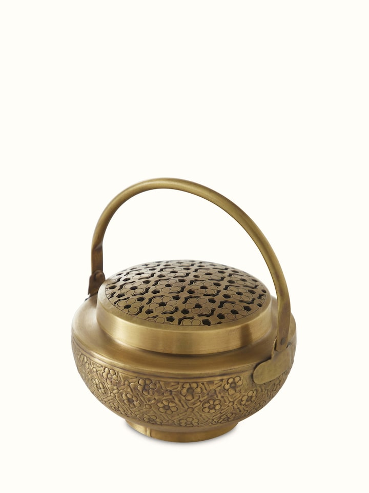 Angled view of Polished Brass Dhuna with Cover