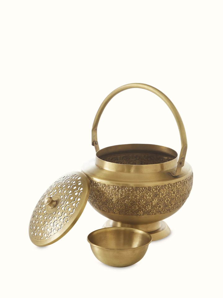 Open view of traditional polished brass dhuna displaying its decorative elements