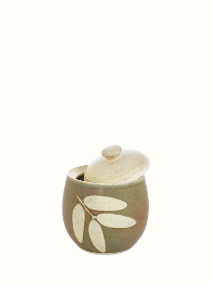 Close-up view of Studio pottery ceramic jar with lid detailing the textured surface and intricate lid design