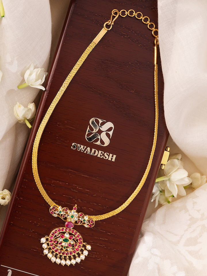 Close-up side angle highlighting the detailed craftsmanship of the gold collar necklace