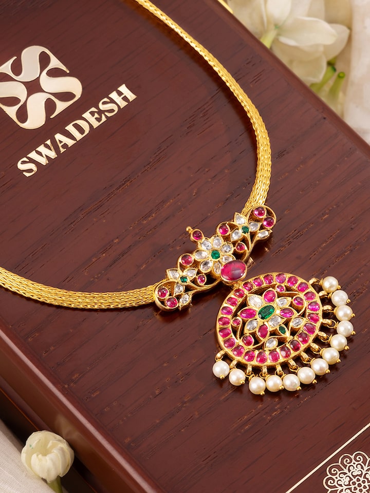 Detailed shot focusing on the delicate patterns and finishing of the gold collar necklace