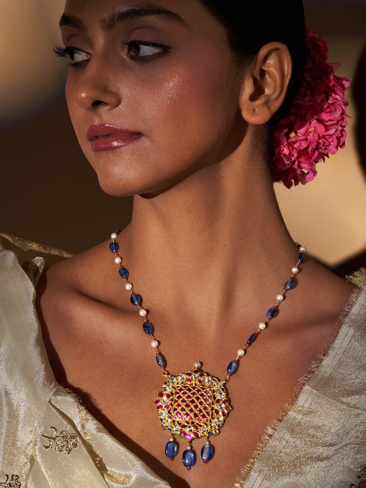 Lifestyle view of Badroom gold pendant styled with festive attire for a rich traditional appeal