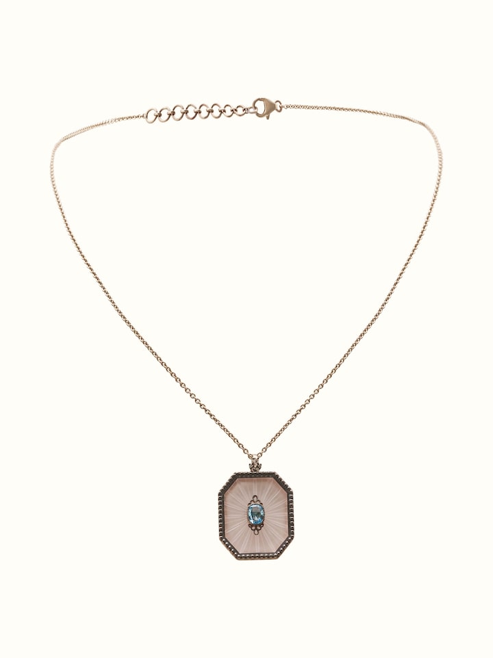 Front view of Lapidary 14 karat gold pendant and chain with faceted gemstone in a minimalist gold setting.