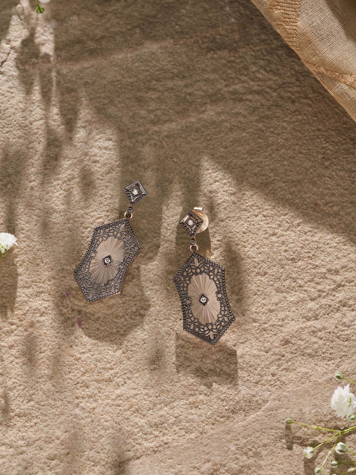 Side view of Lapidary 14 karat gold drop earrings showcasing detailed goldwork and sophisticated design