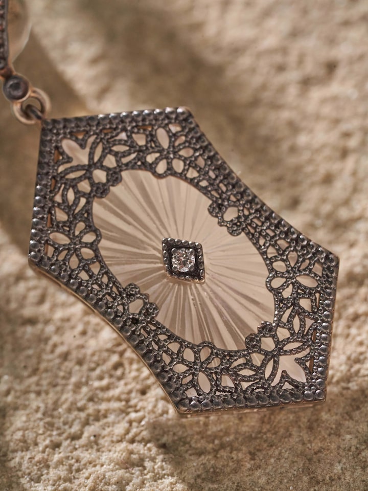 Close-up of Lapidary 14 karat gold drop earrings highlighting fine gold detailing and luxurious finish