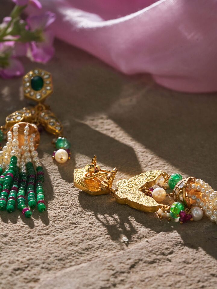 Angled view of Thappa 22 Karat gold earrings highlighting design depth and rich finish.