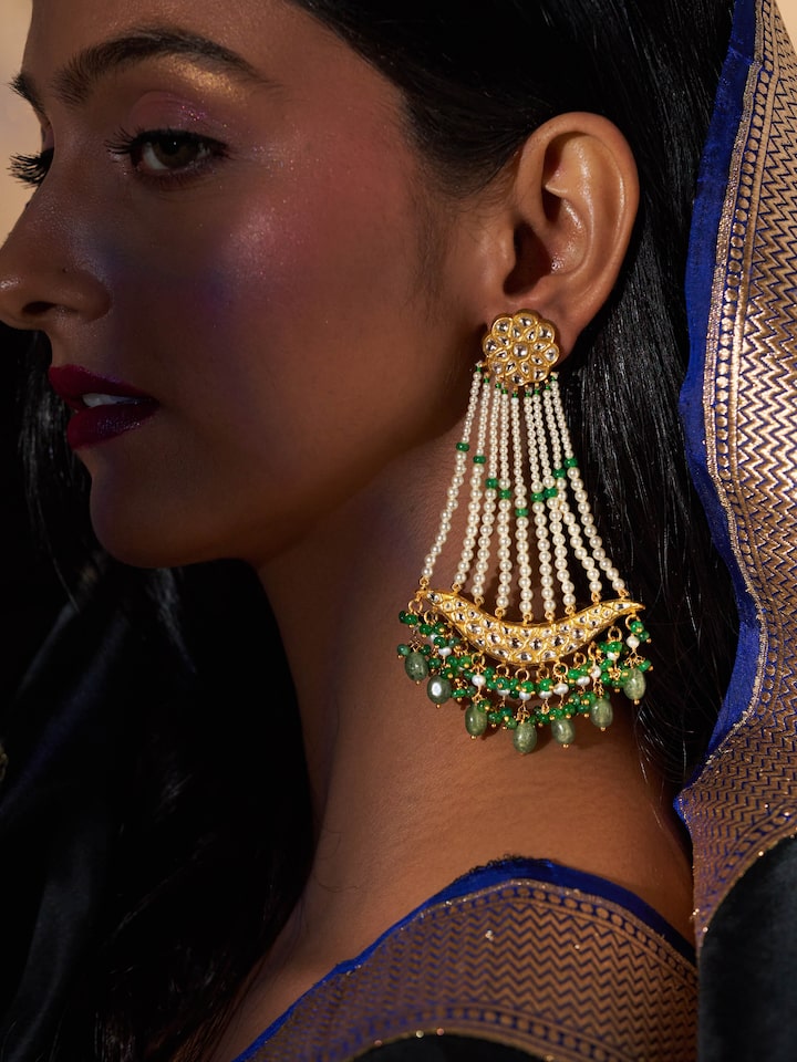 Lifestyle view of gold drop earrings paired with traditional outfit for elegant look