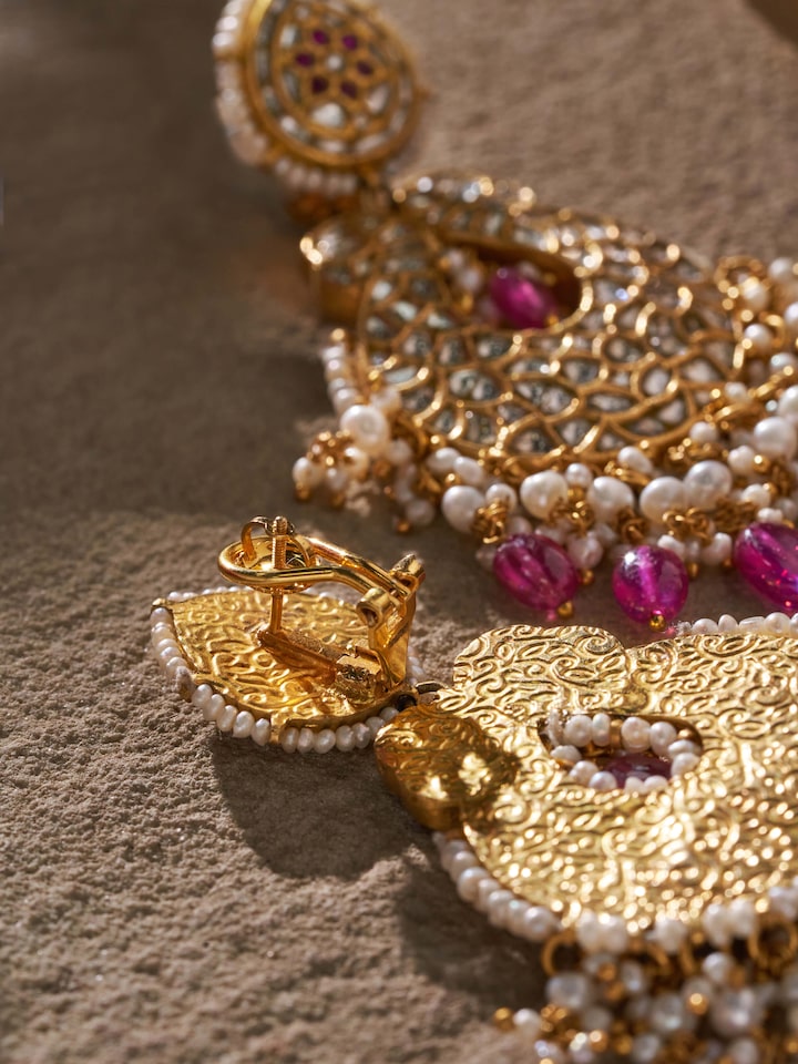 Front view of 22 karat gold drop earrings with focus on design and elegance