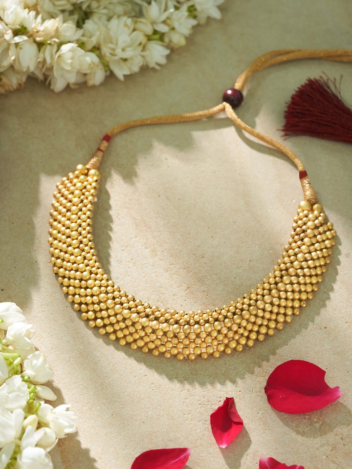 Lifestyle shot showcasing gold Thushi necklace paired with ethnic Indian attire