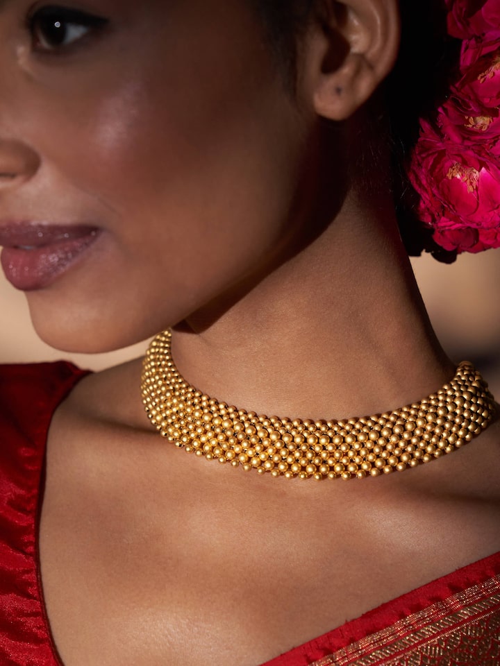 Side lifestyle view of 22 Karat Thushi necklace styled with festive wear