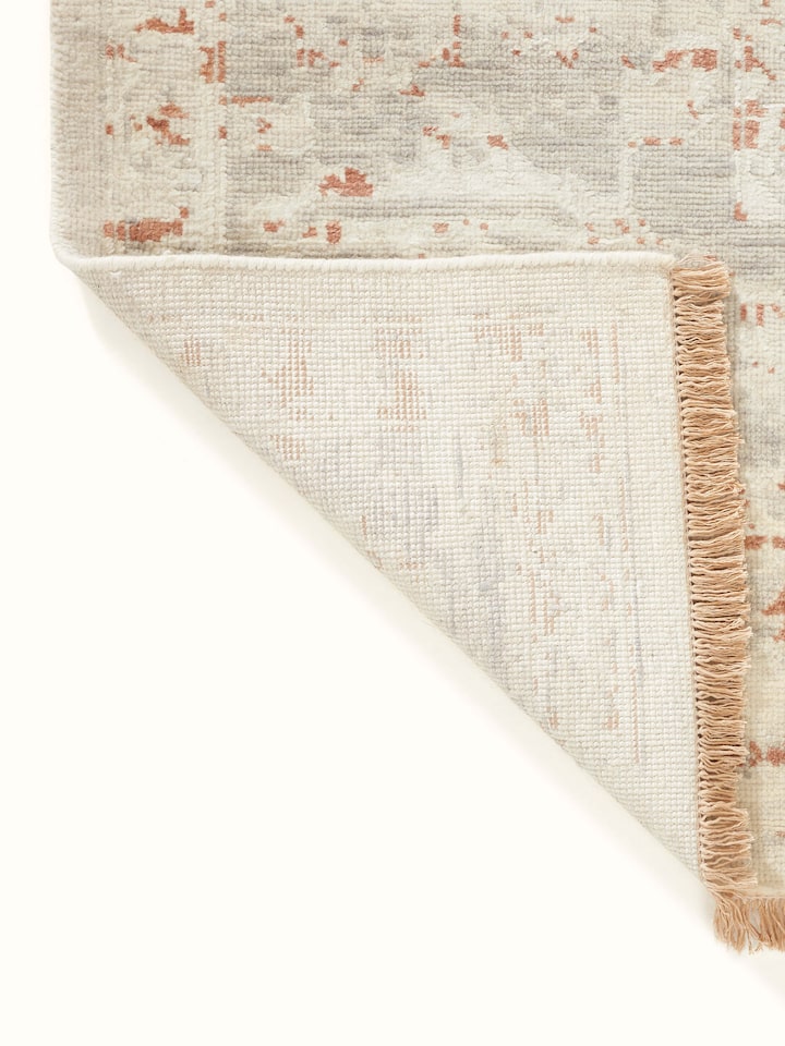 Overhead view of Distressed transitional beige rust Bhadohi wool & silk hand-knotted rug highlighting its large size and pattern.