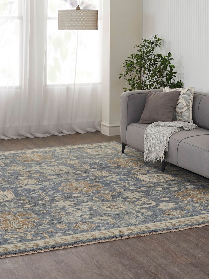 Lifestyle setting with traditional blue Oushak wool rug adding vintage charm to the interior.