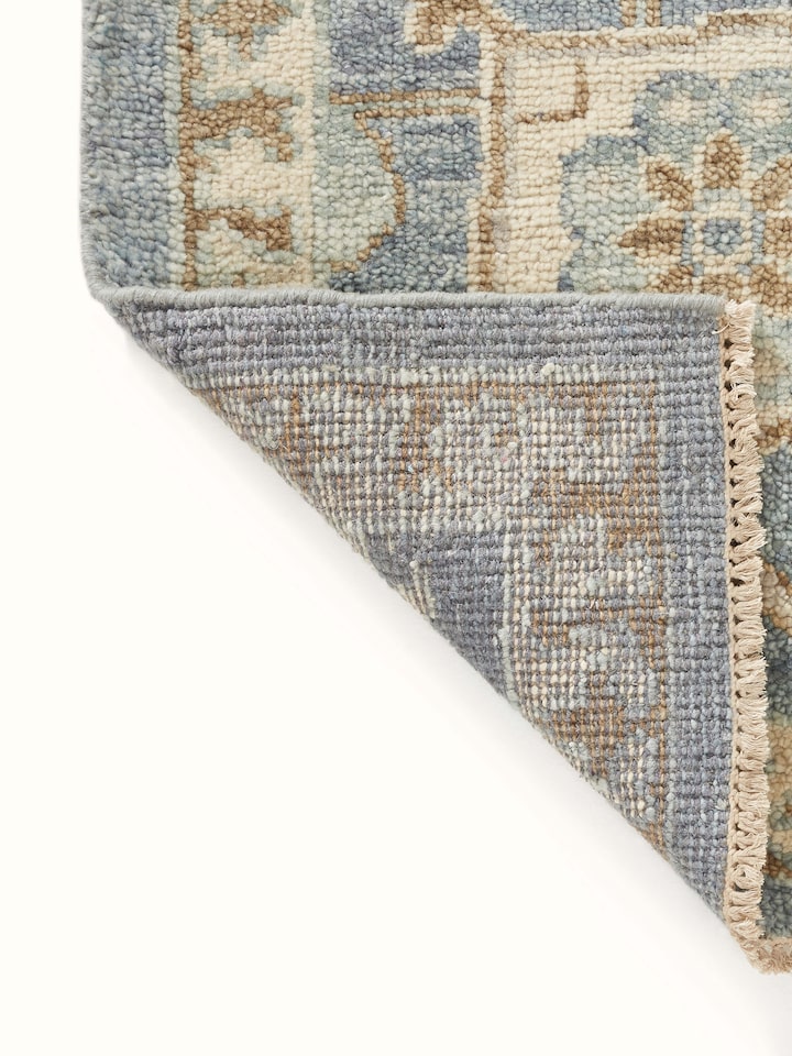 Detailed view of Oushak traditional blue Bhadohi wool hand-knotted rug kharad showing the intricate knotting and design.