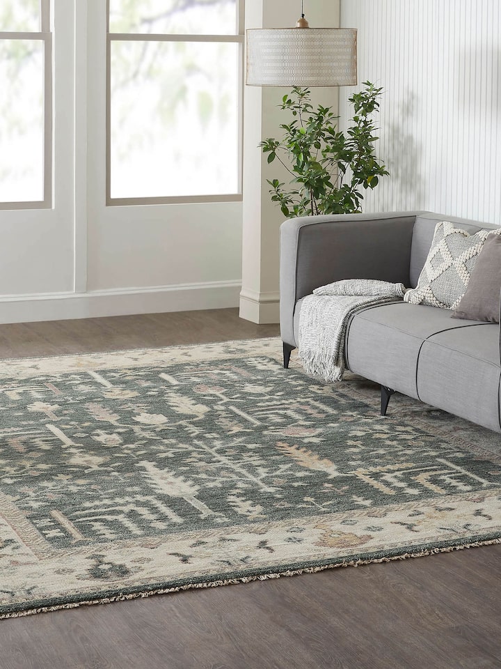 Lifestyle shot: Oushak green wool rug styled in traditional living space with rich heritage detailing.